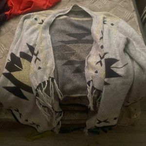Gray open sweater, with a black an gold accent and it’s from escio